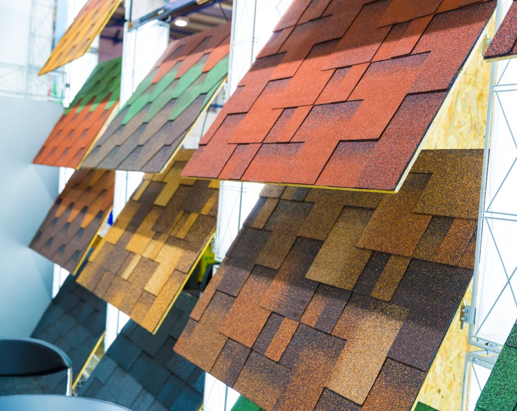 Display of asphalt shingle roofing samples in various colors and styles