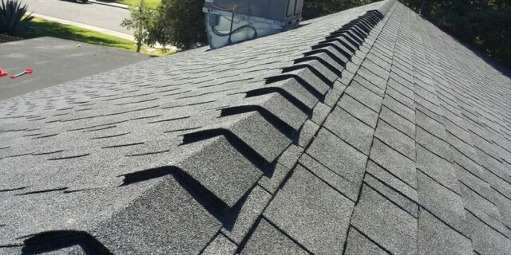 Close-up of asphalt shingle roof ridge with proper installation